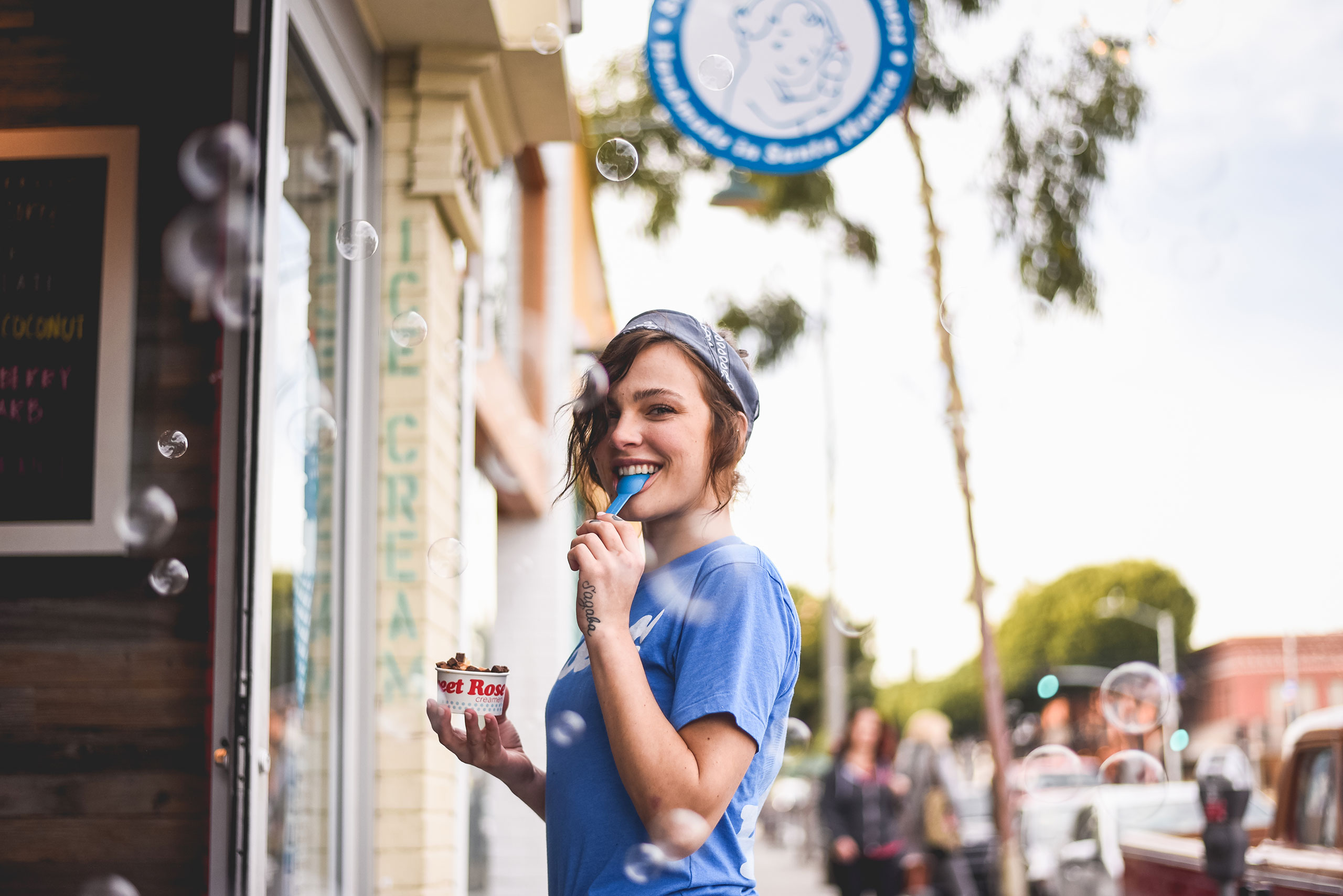 Female employee eating ice cream from a cup at the Main Street shop