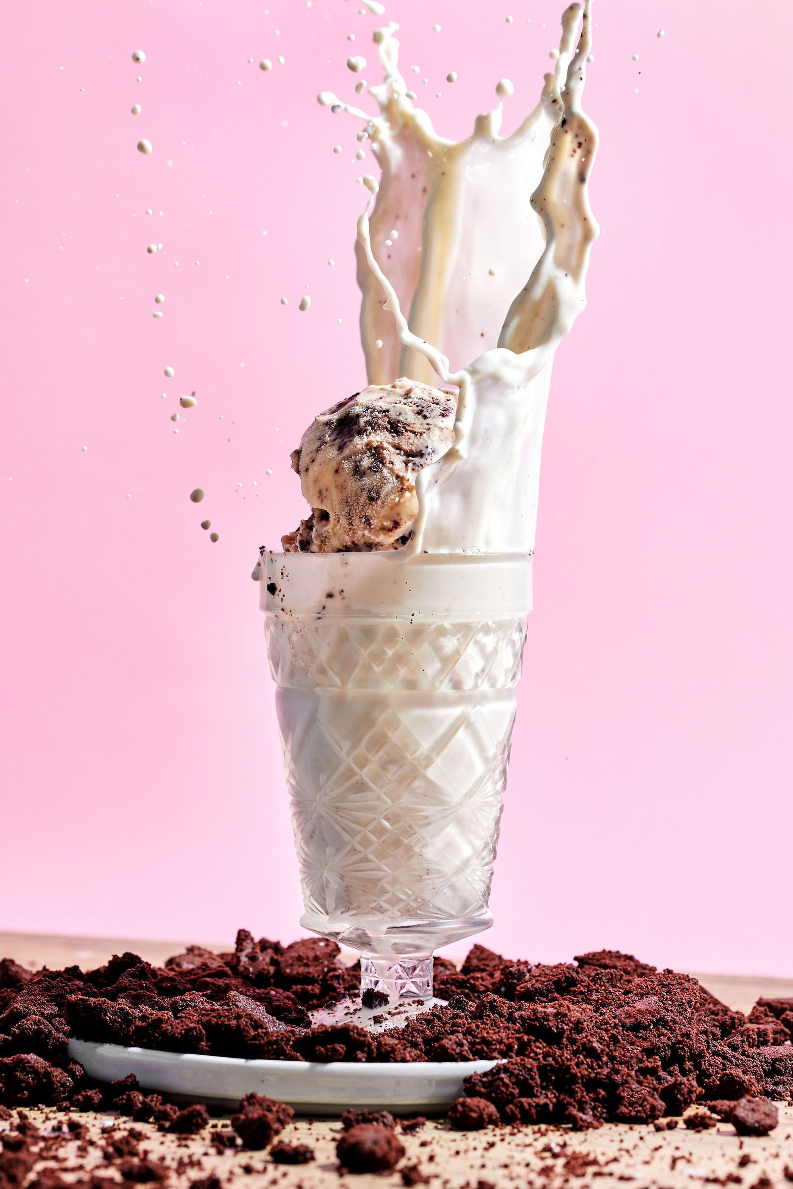 Cookies & Cream Ice Cream scoops of cookies & cream ice cream with a splash of milk and chocolate cookie crumbles