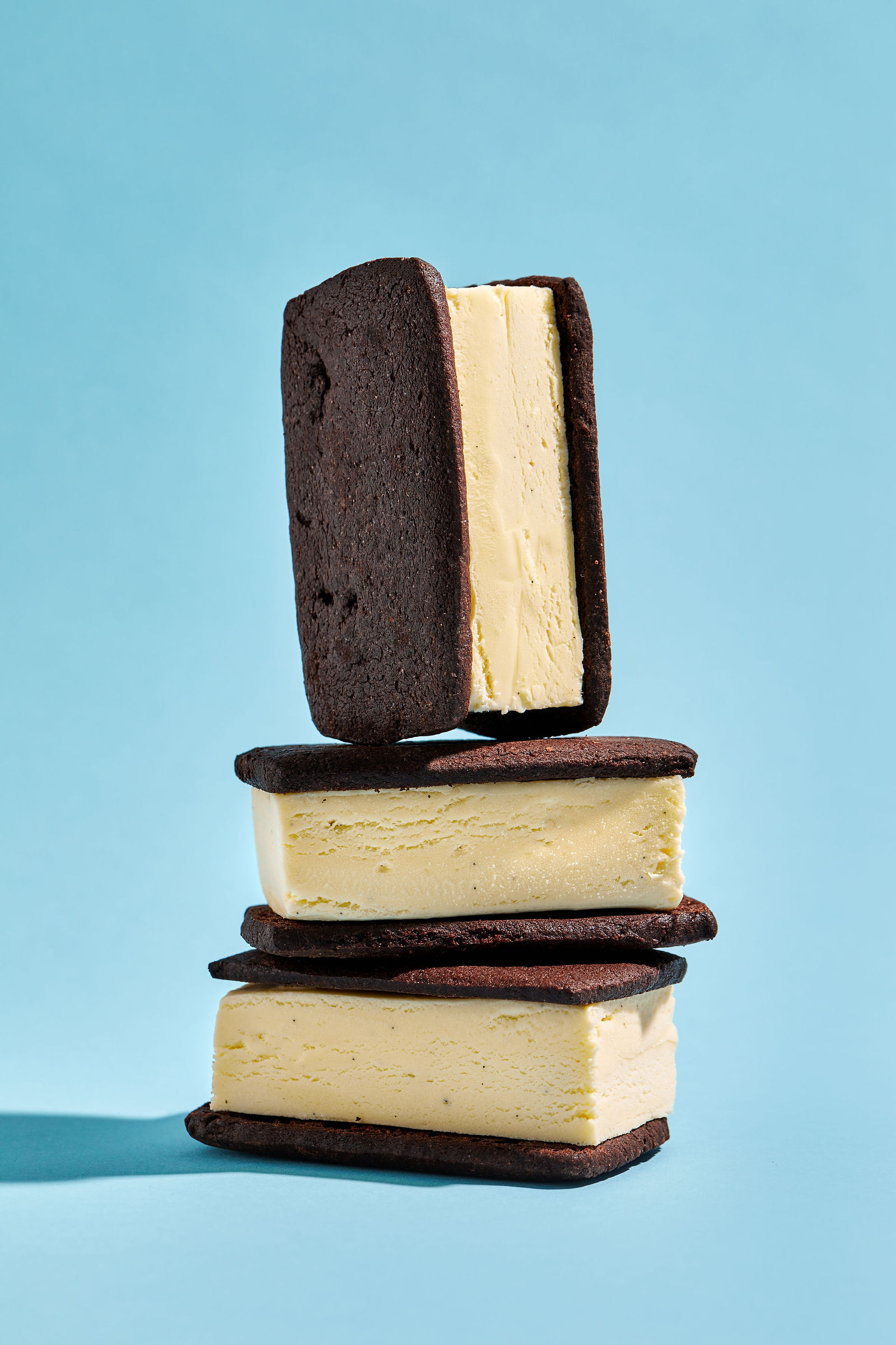 three vanilla ice cream sandwiches stacked on top of one another