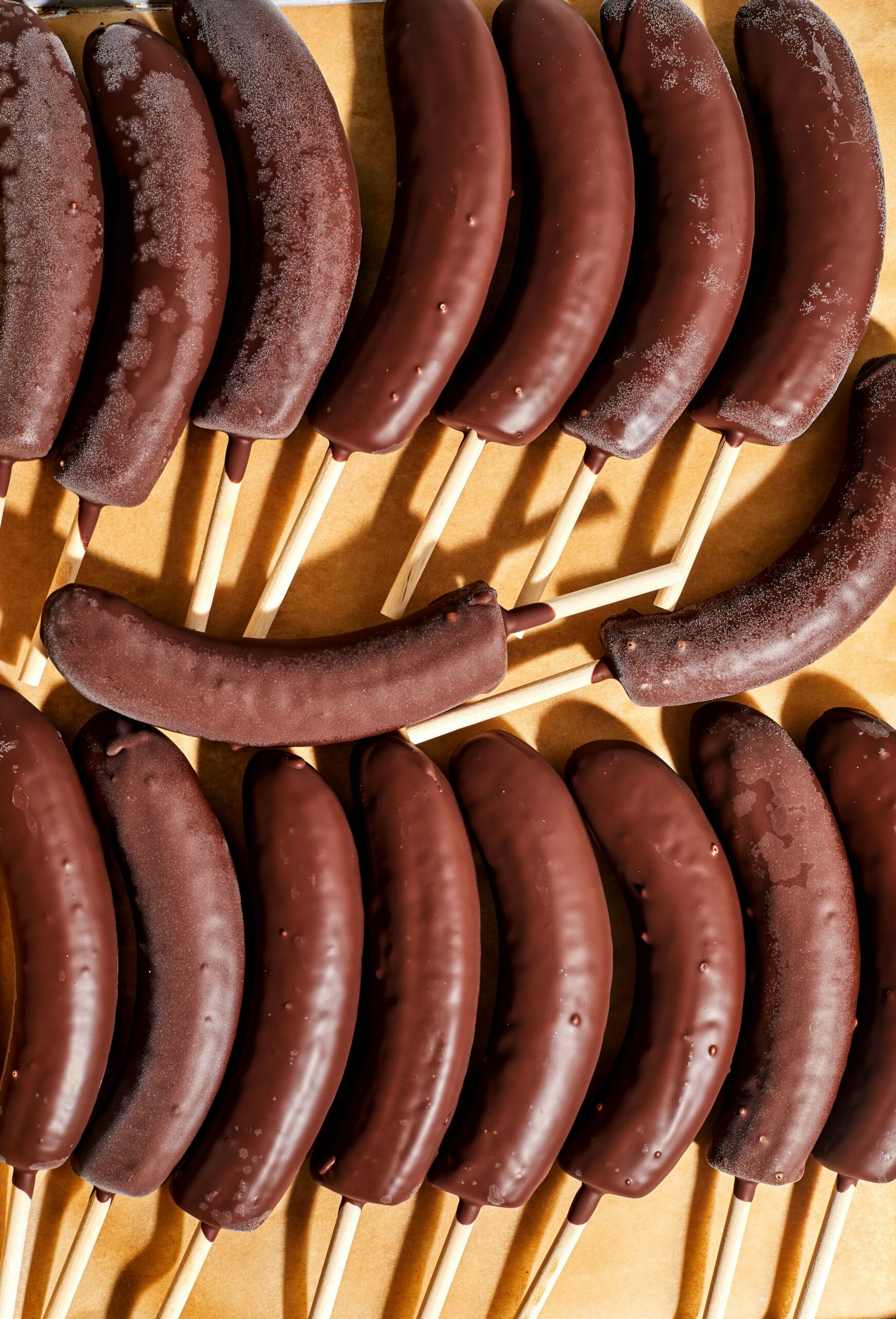 Chocolate-Covered Bananas a tray of frozen bananas dipped in chocolate fudge